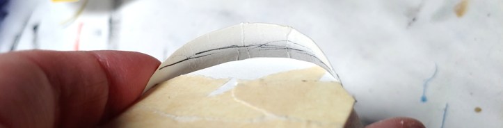 Marking the top strip on the front face with a pen (strip held slightly askew to make the marks easier to see)