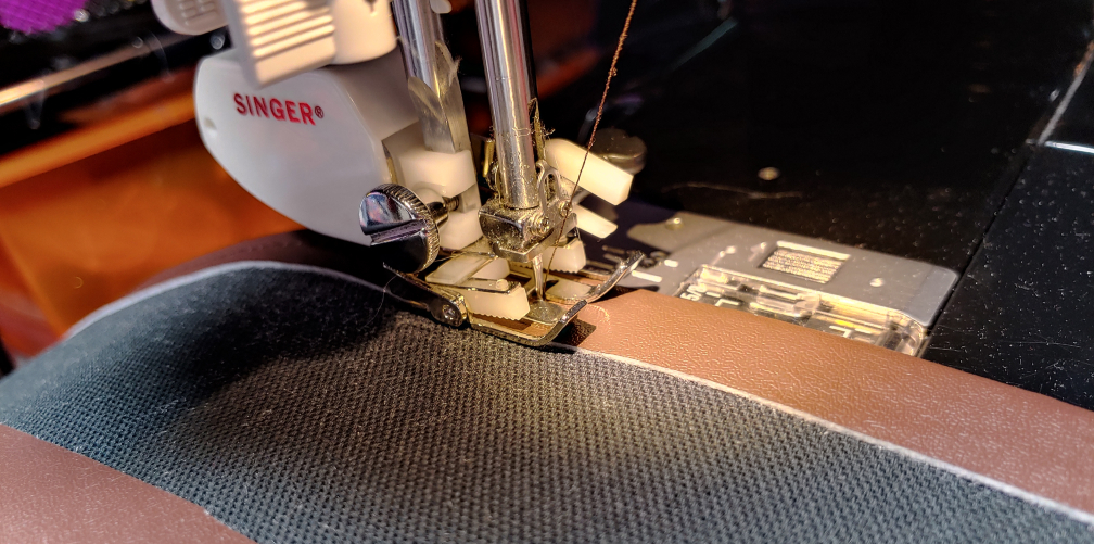 Sewing the belt using a walking foot. The belt is face-down on the sewing machine.
