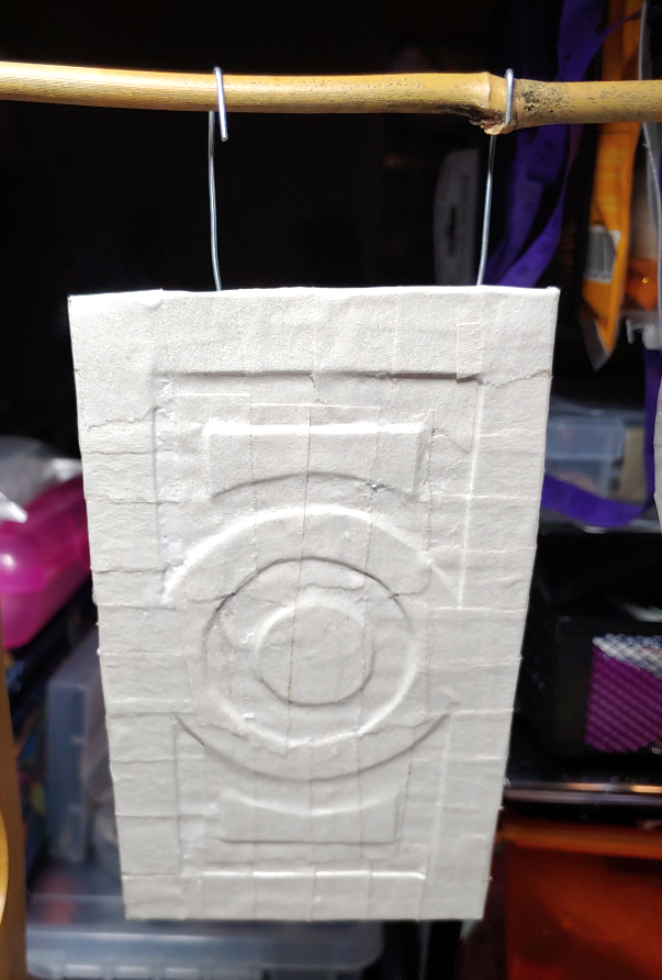 Buckle suspended from a bamboo plant stick with bent wire so it can dry completely