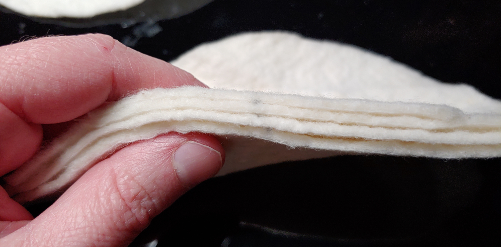 several layers of quilt batting placed together to make 1/4" shoulder pads