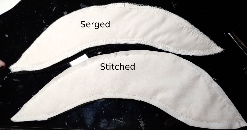 Finished sleeve head rolls, serged and stitched to show the difference in finishes. The top is serged with the looped stitches around the edges. Bottom simply is stitched using a straight stitch.
