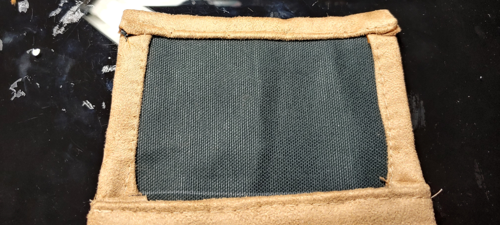 Flap folded and sewn. The top is folded over the sides and sewn down with a straight stitch.