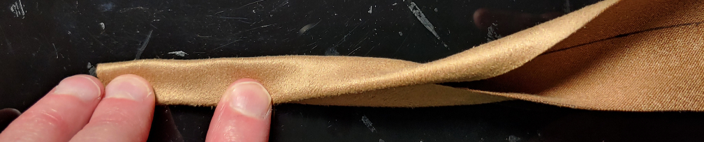 The belt loop fabric folded a second time to make a finished belt loop.