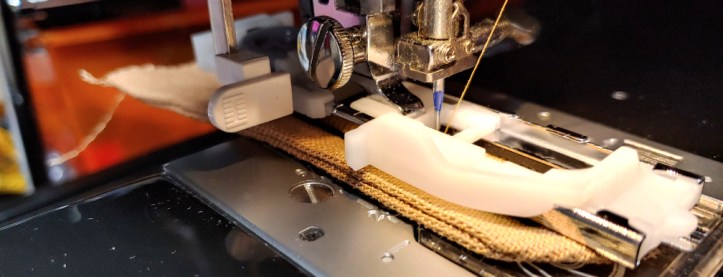 A buttonhole foot fully extended, the sensor bar hitting the stop guide in the back