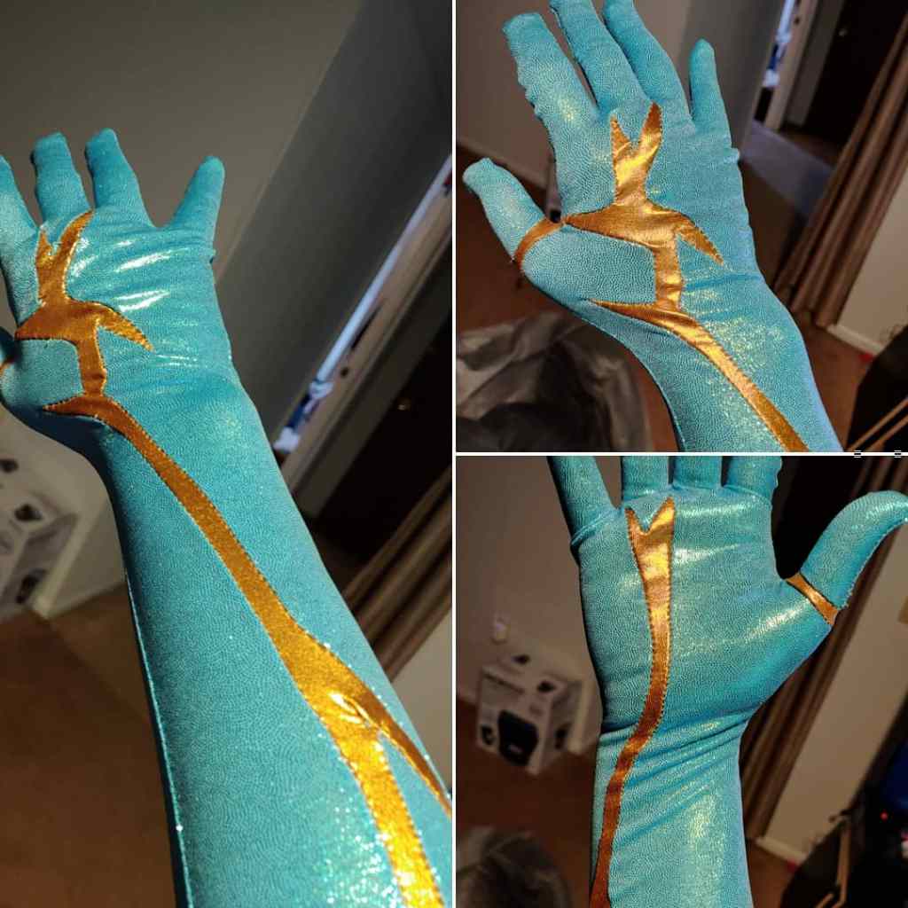 Color blocked gloves. Blue gloves with veins of metallic gold blocked into them.