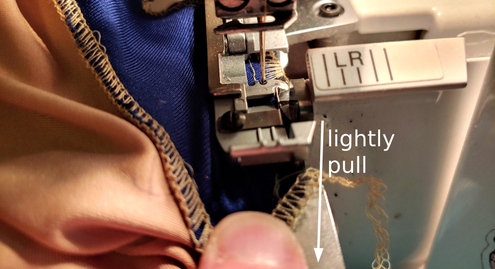 Sewing curves by lightly pulling on the fabric and manipulating it. The text next to the arrow pointing downward says "lightly pull"