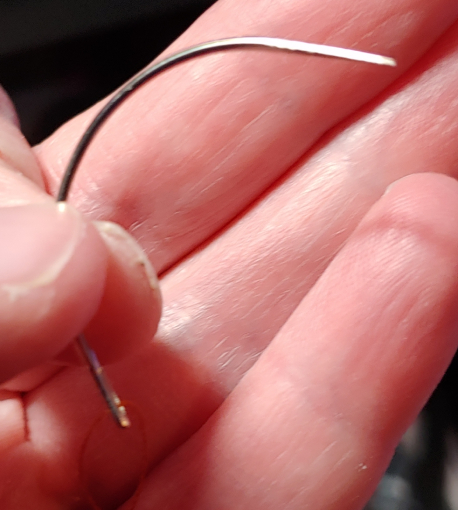 A basic curved needle, curved so that it looks like a big C