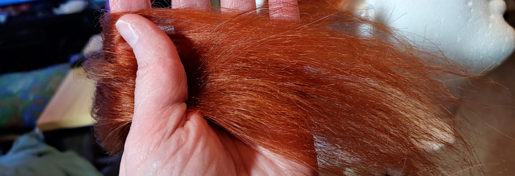 The fibers are detangled, now looking very fluffy and much thicker than the original wefts.