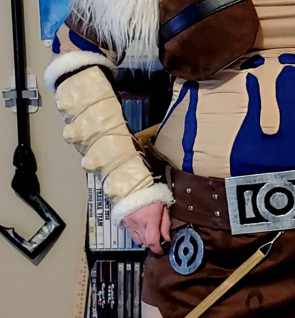 Bone glued to gauntlet with suede laces worn with the rest of the cosplay on