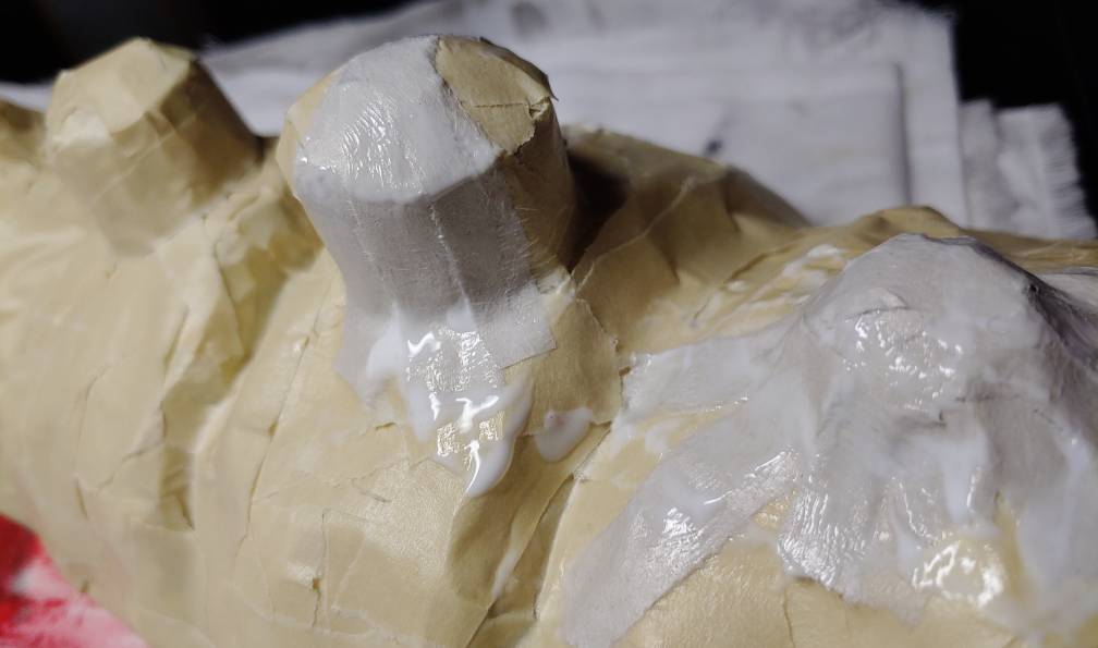 Thin strips cover the bumps and cylinder bone structure evenly. The smaller bump on the right is completely covered with strips while the taller one on the left is partially covered.