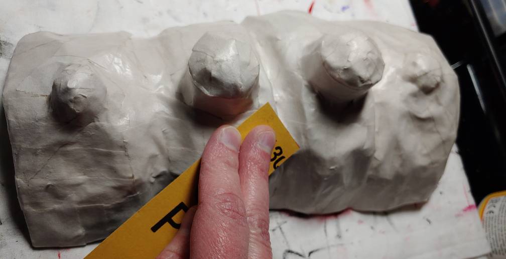 Sanding the bone with a cut of sandpaper