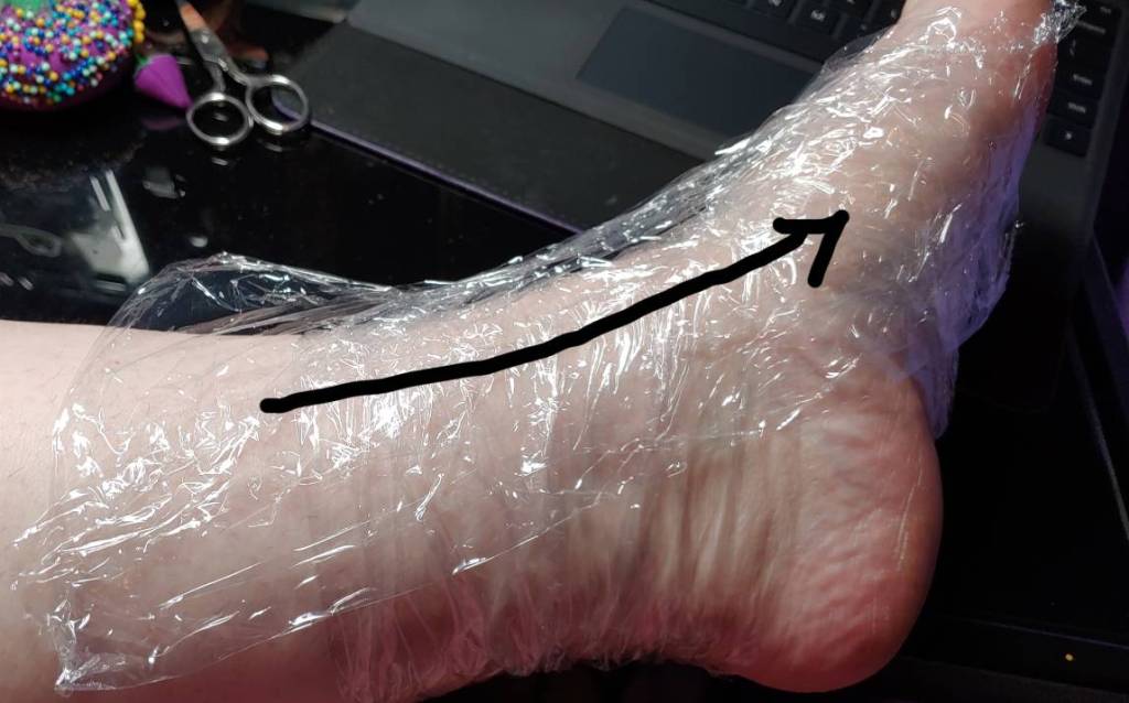 Filling in the gaps from ankle to foot for peep-toe sandals. A black arrow shows how to lay the strips across the side of the foot.