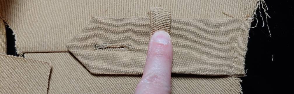 Testing out the placement by folding the carrier around the tab. My finger is holding it in place as it isn't sewn yet.