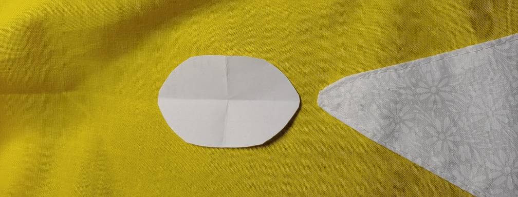 Paper oval placed at the top of one of the flounces to check the size