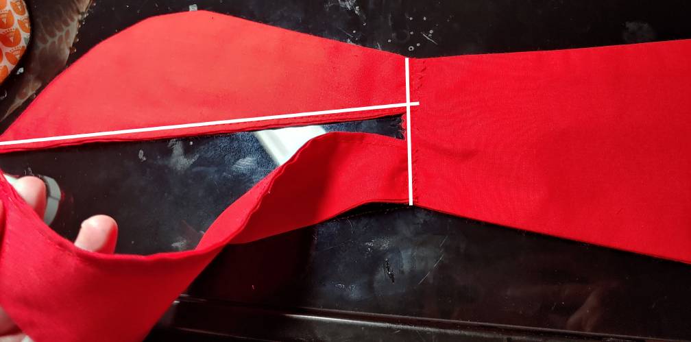 Scarf and tie connected. Stitch to connect and the scarf neckline stitch are shown in white.