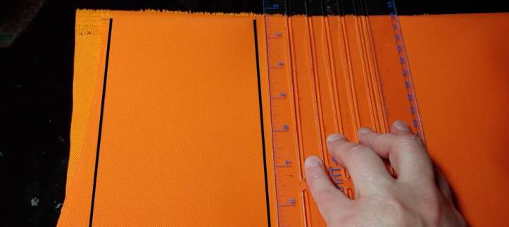 Using the tailor's ruler to draw a 4" wide strap