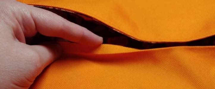 Lid with the ironed lip flipped upward to show the crease