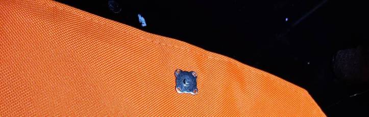 Magnetic snap sewn at the center top of the lid about 1" away from the edge