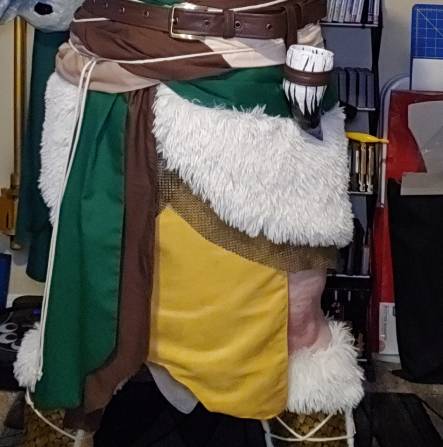 Finished irregular hem in brown and green cotton and yellow suede