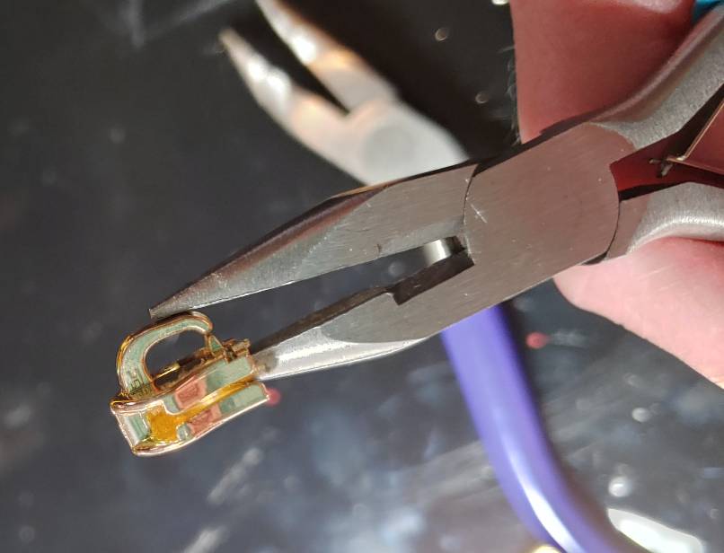 Closing the bar on the slider. The removable pull tab isn't inserted here