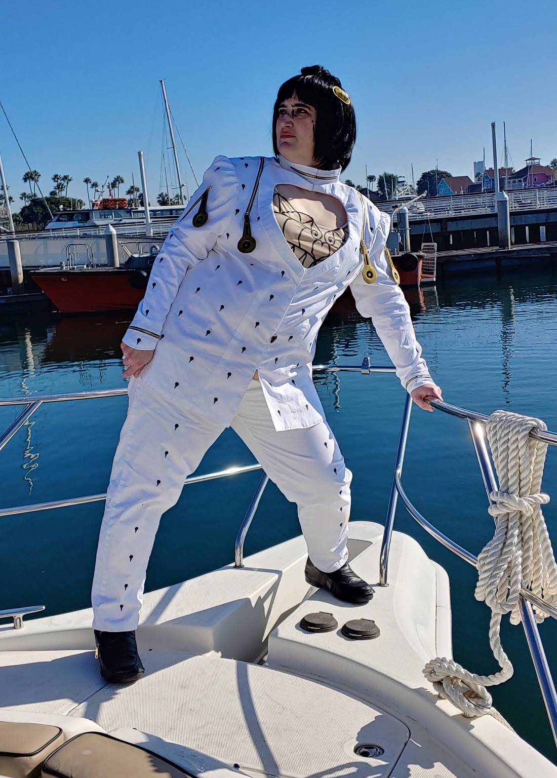 Bruno on the front of a boat in a harbor