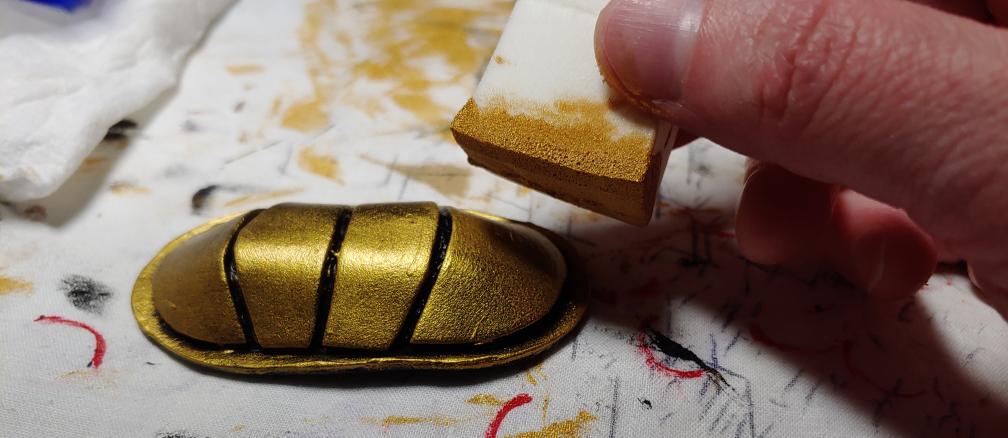 Painting the clip a brilliant metallic gold with a makeup wedge