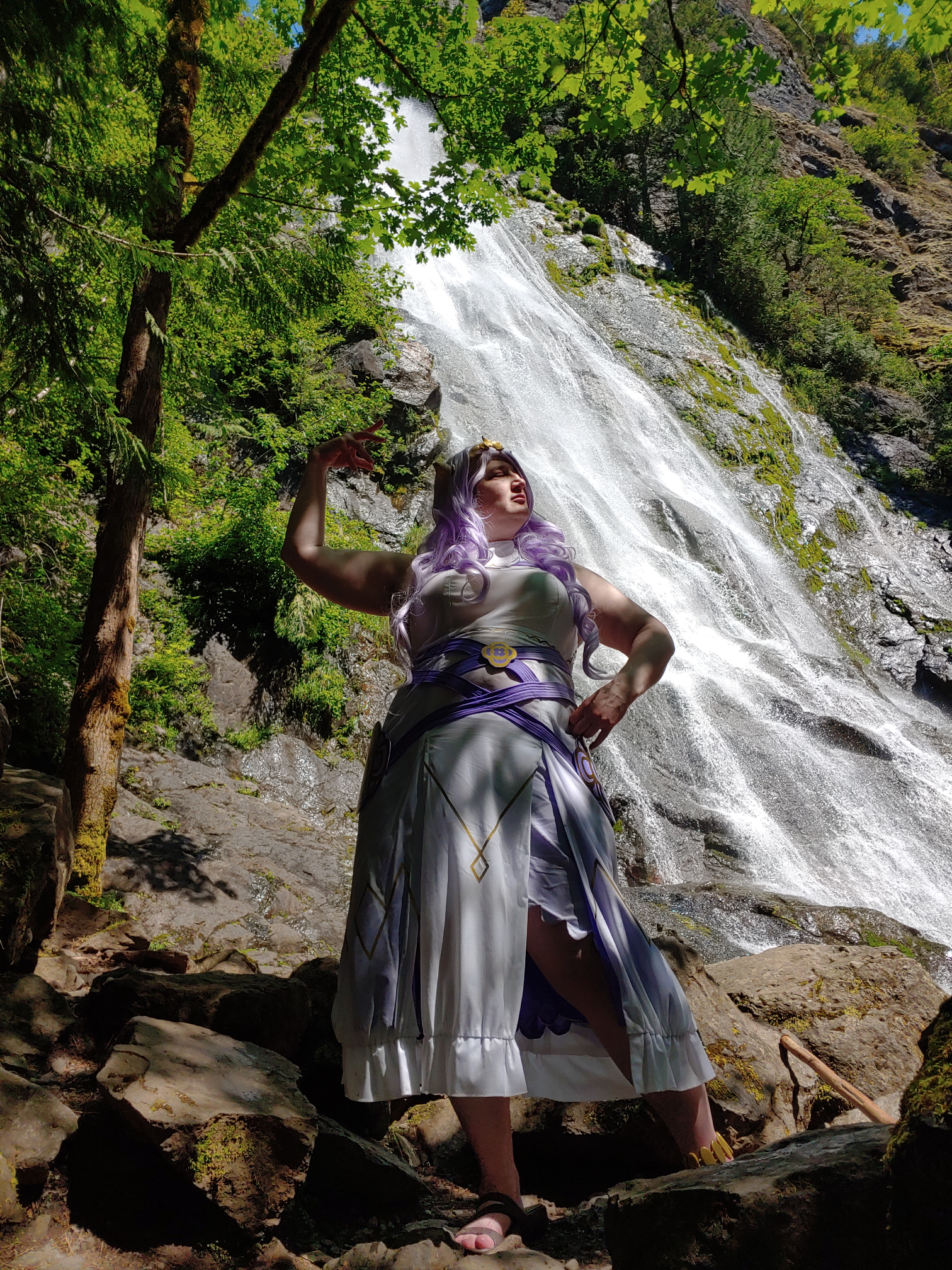 Standing in the shadows with a rushing waterfall in the background
