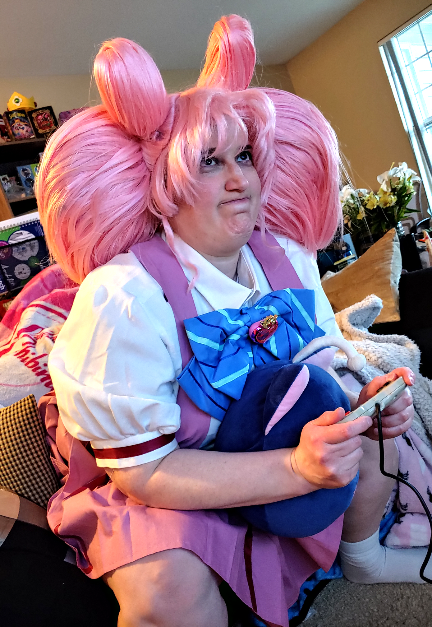 Chibiusa getting annoyed at video games with a SNES controller in hand and Luna-P shoved in her lap.
