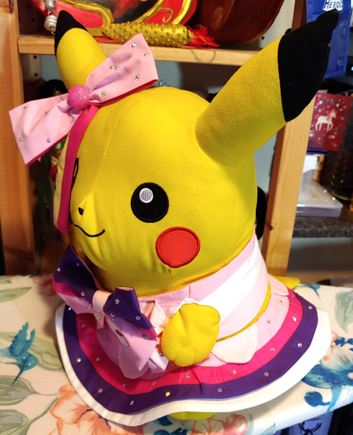 Cosplay Pikachu sitting sideways on an ironing board