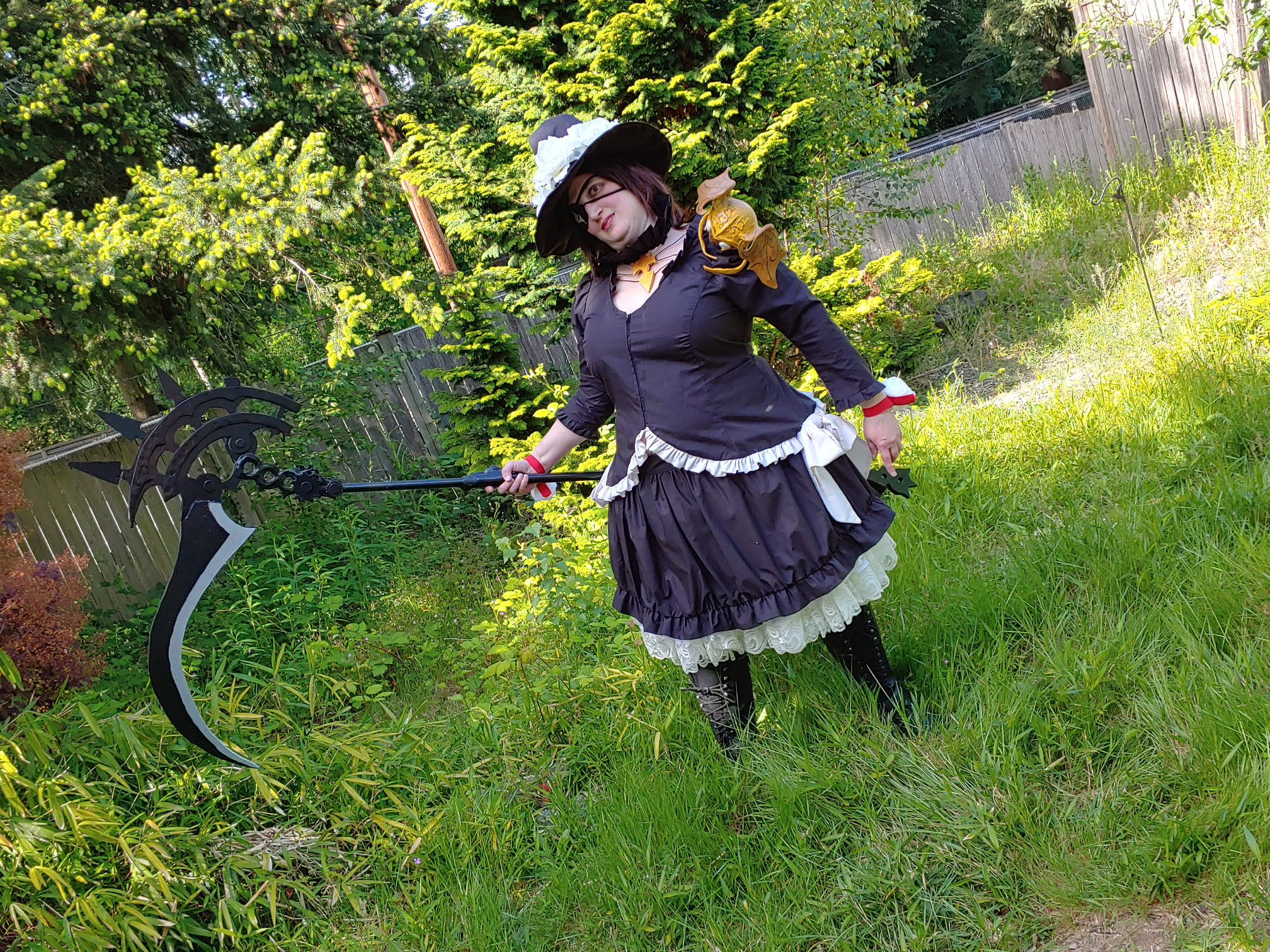 Landscape shot of Edda holding the scythe out, looking crazily for the player character