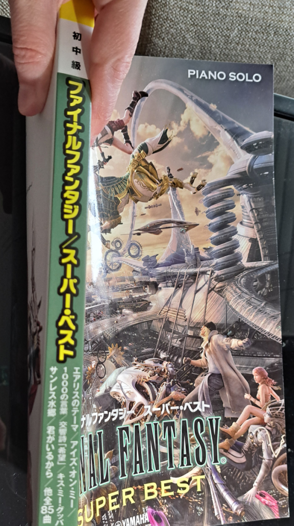 Showing off the green spine which says "Final Fantasy Super Best" in Japanese