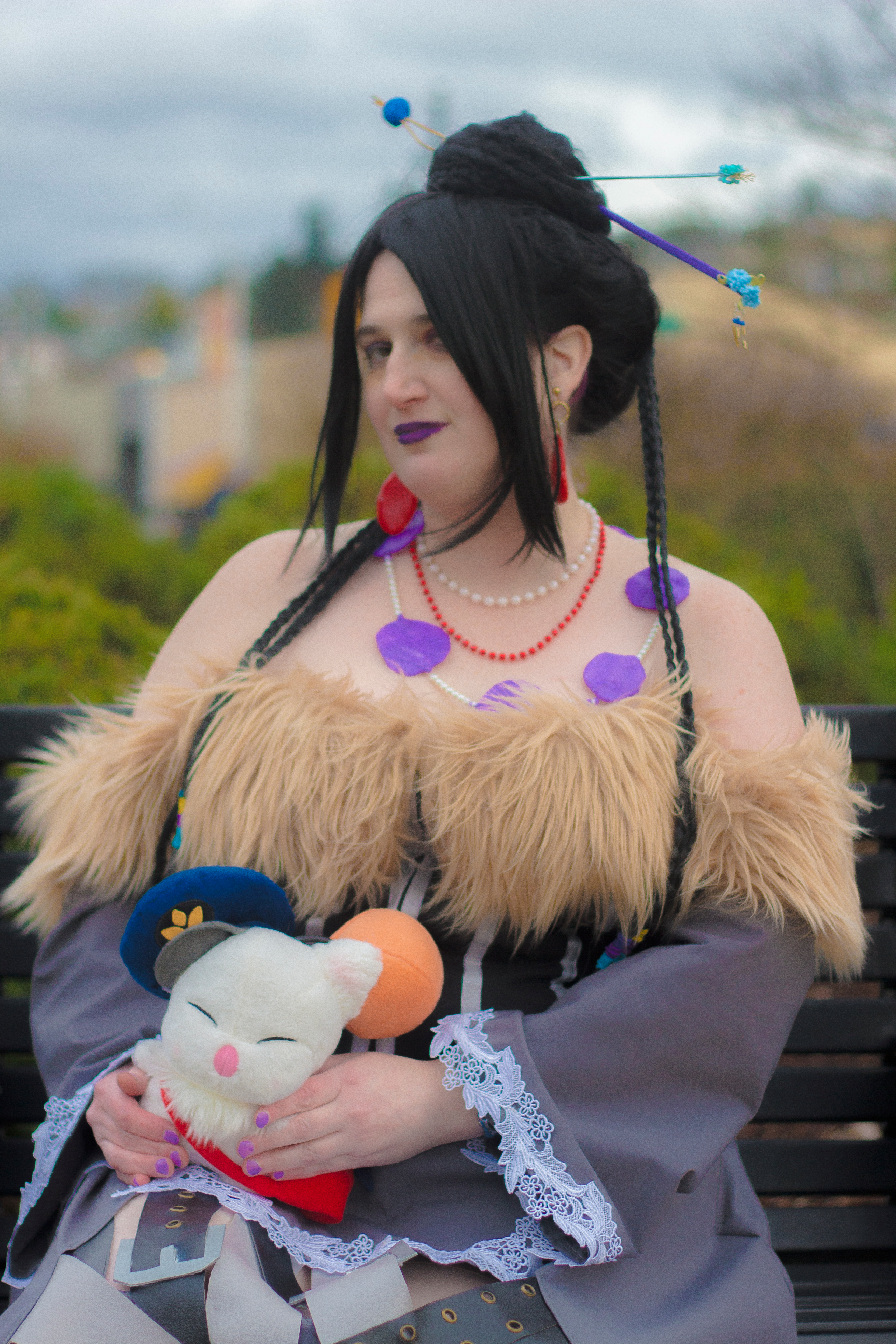 Lulu sitting with a moogle on lap