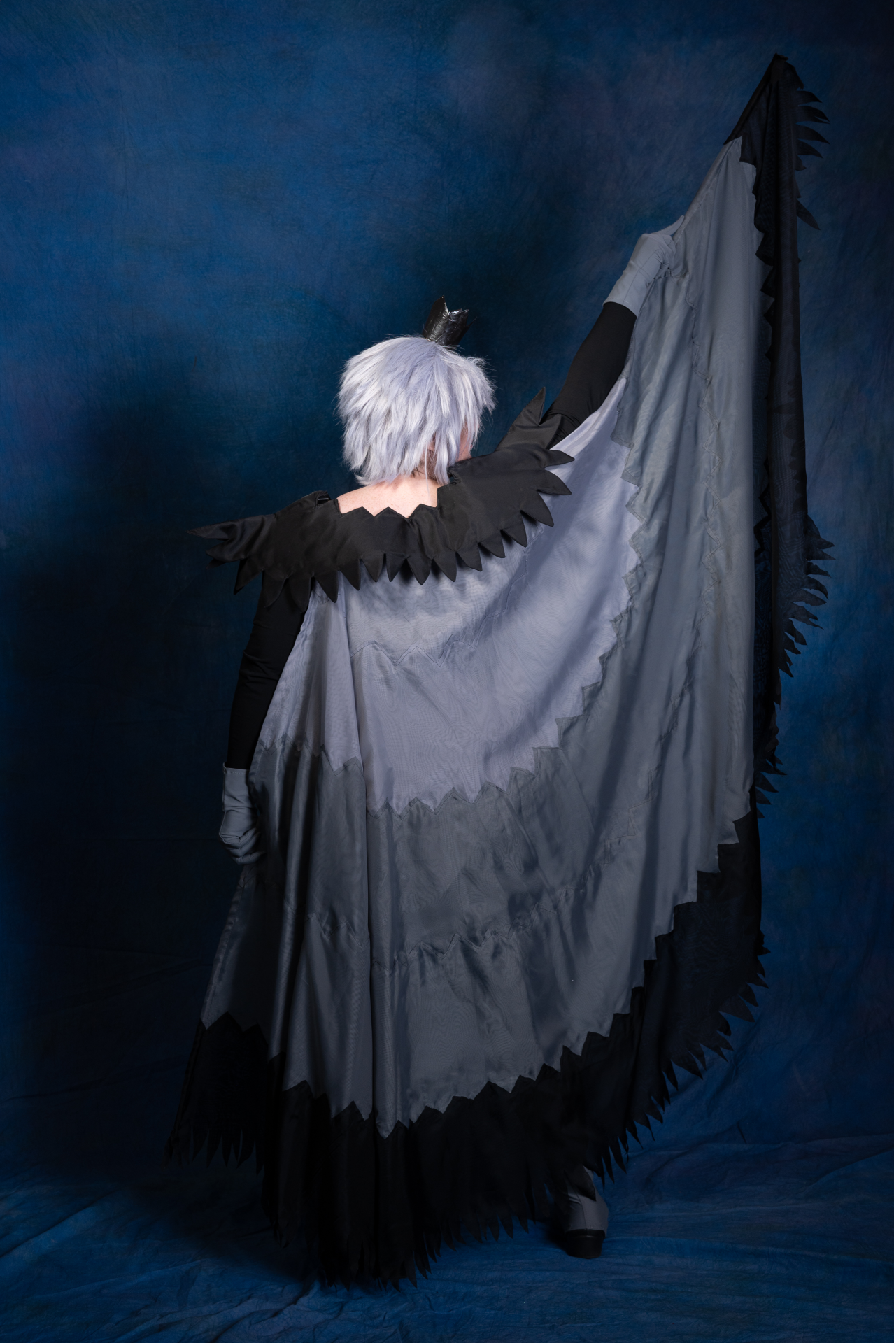 The back of Mytho's outfit, one arm outstretched upward to show off the wings