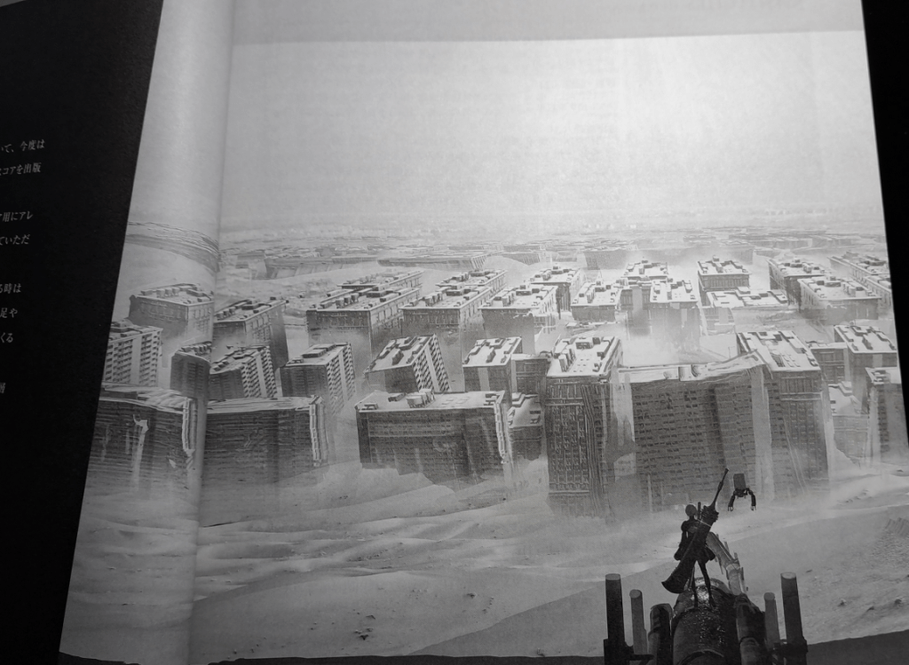 2B standing with a sword in front of the building ruins partially sunken into the sands