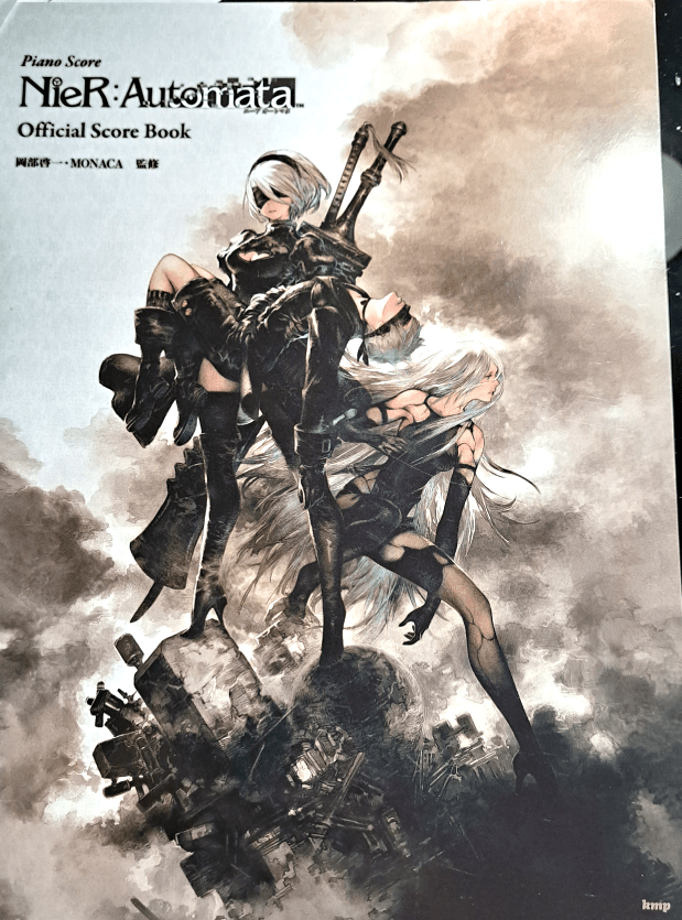 Front cover with dusty clouds in the background. Foreground is A2 leaning on the right, 2B on the left holding 9S in her arms