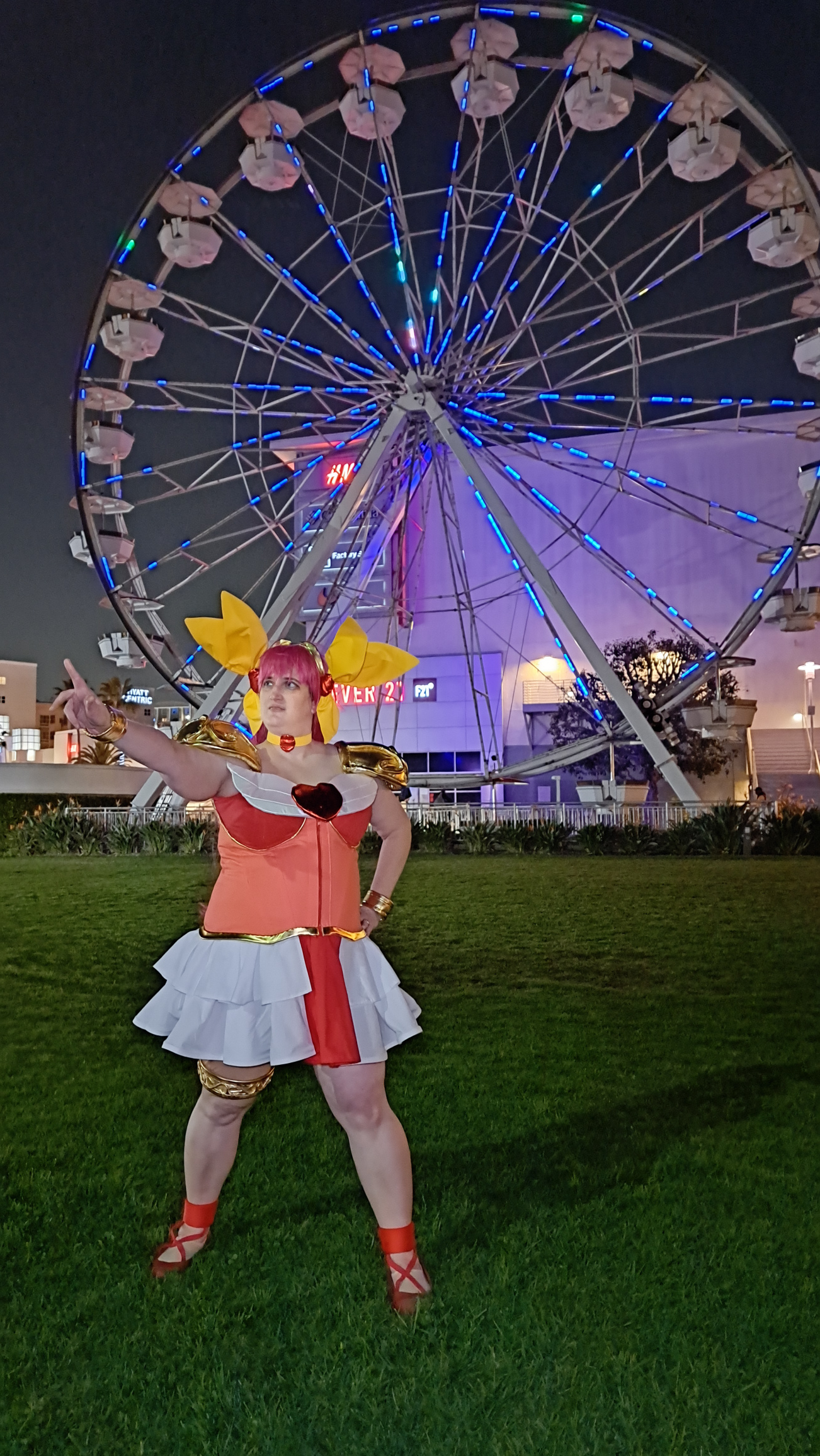 Peach giving an intro speech to the bad guys in front of a ferris wheel with colorful lights on the spokes