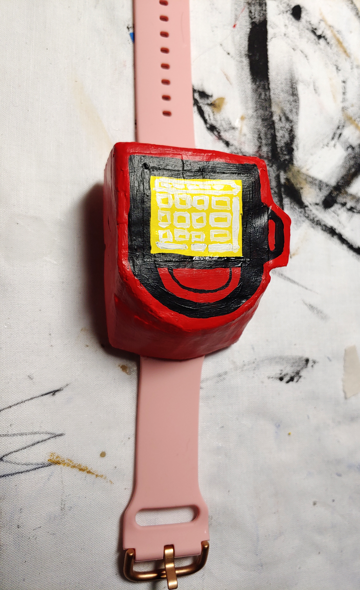 Poketch sitting on a white drop cloth