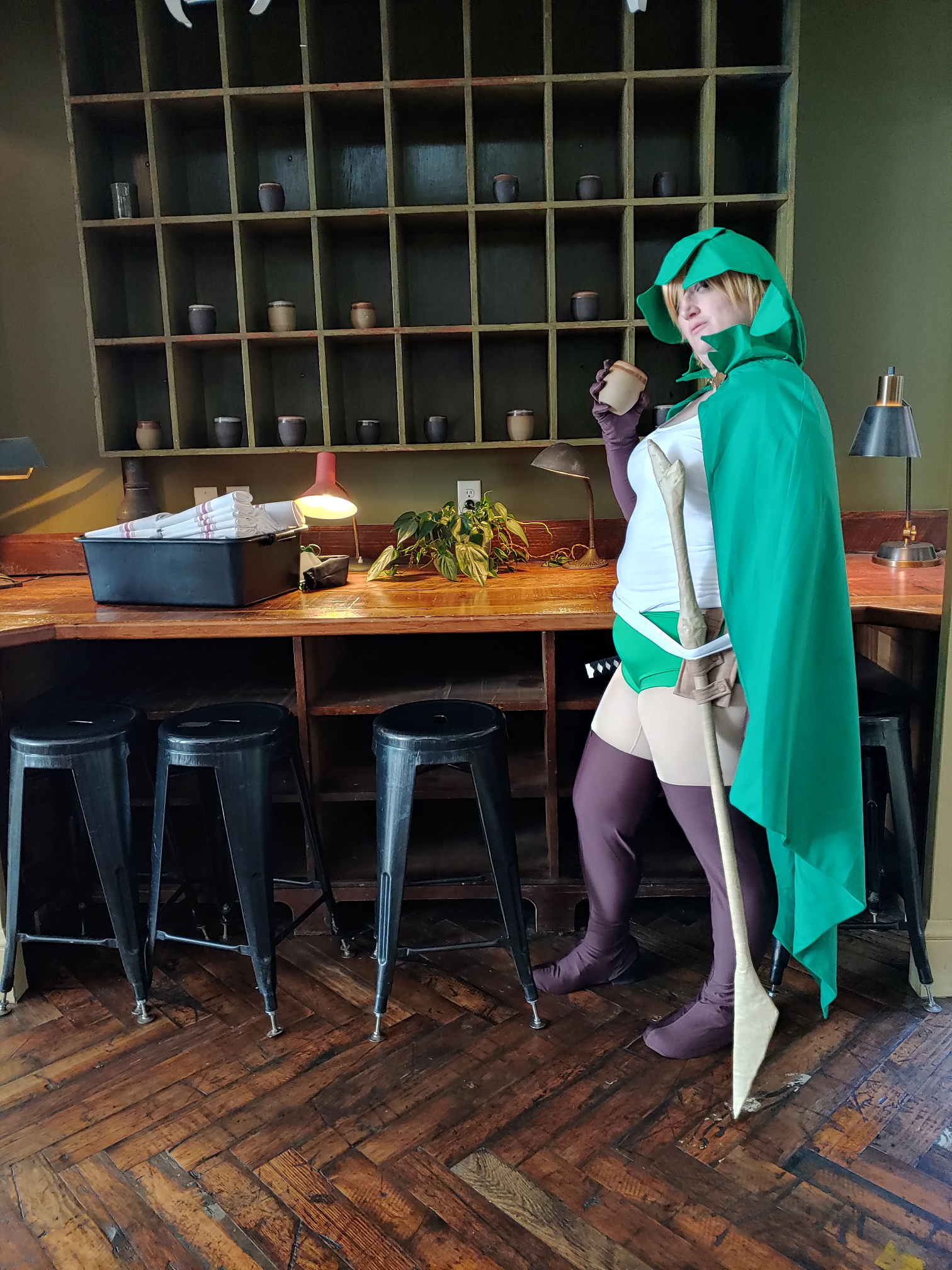 Ryu standing at a bar, mug in hand