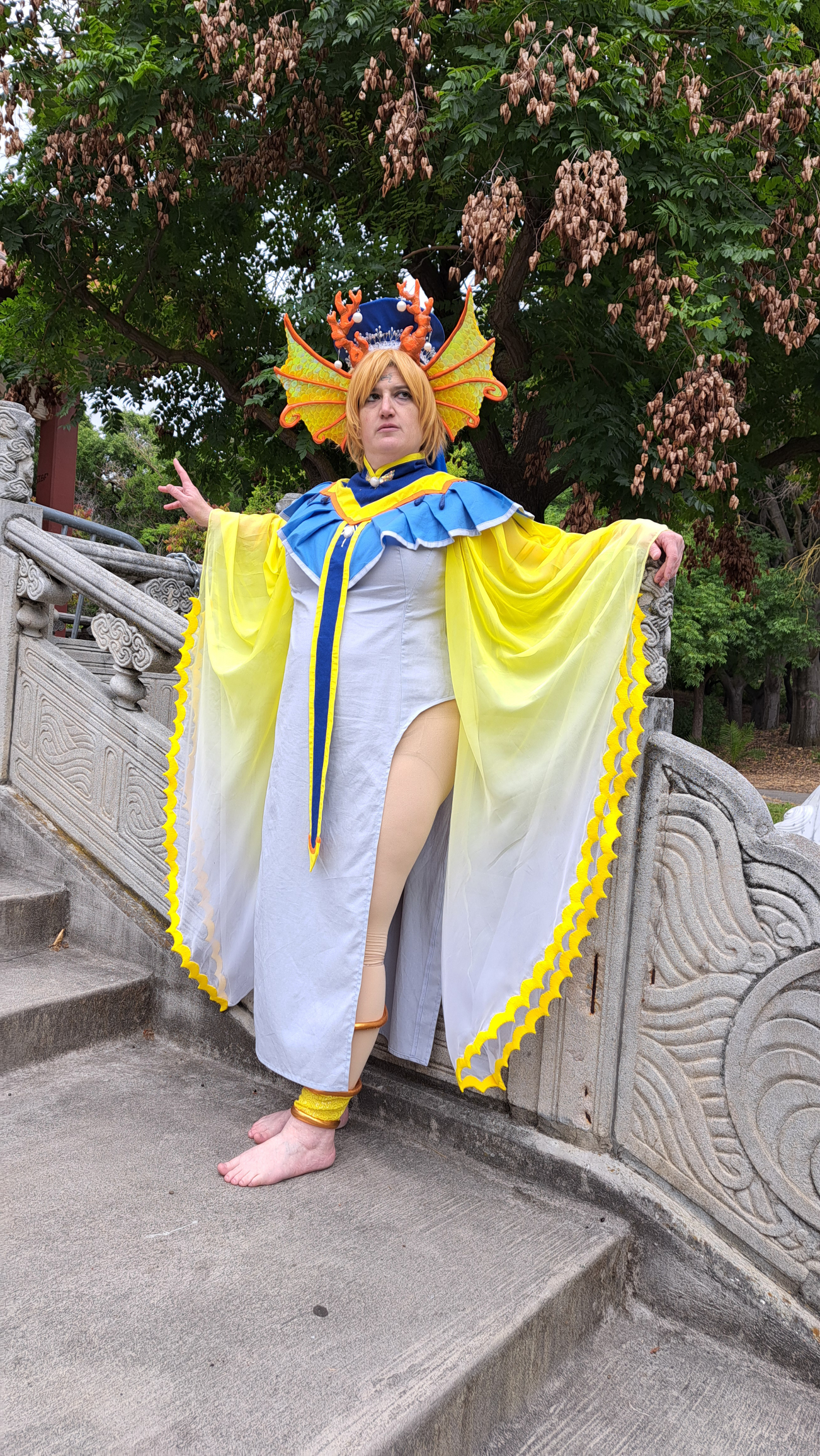 Yui leaning against a stone railing