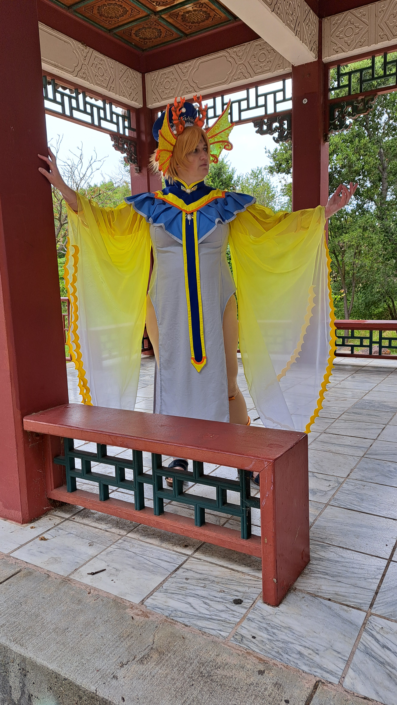 Yui in a red, black, and beige temple