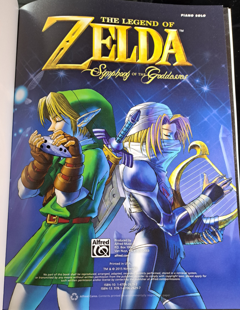 Color title page with "The Legend of Zelda Symphony of the Goddesses" written in gold at the top. Link (left) plays the ocarina and Shiek (right) plays the harp