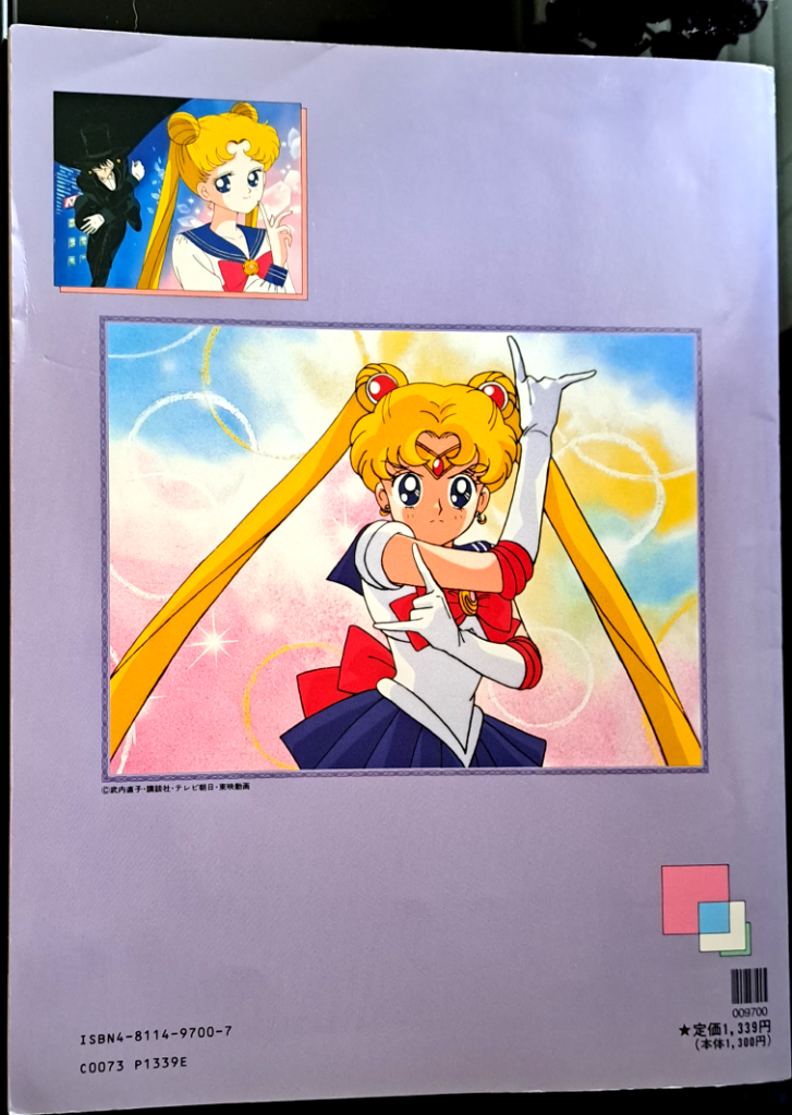 back cover with a lavender background. The top left image is Usagi with Tuxedo Mask in the background. The large center image is Sailor Moon in her intro speech pose