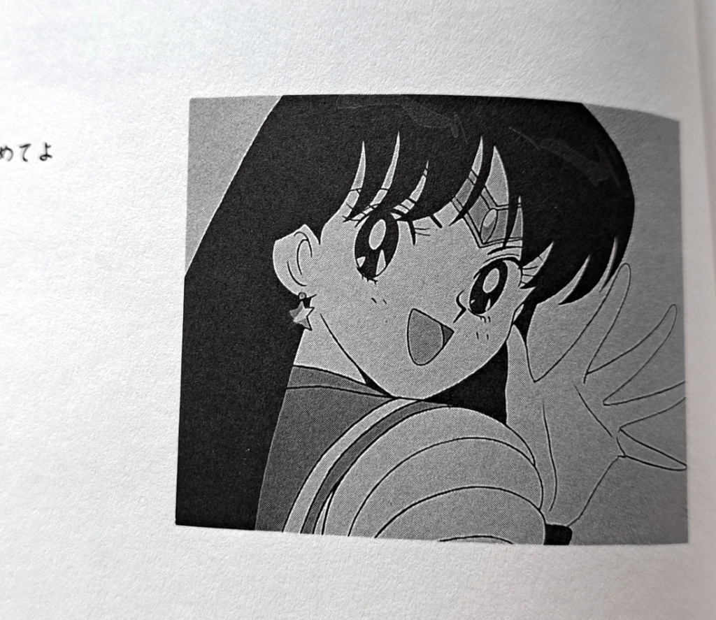 Grayscale screenshot of Mars looking over her shoulder happily and waving