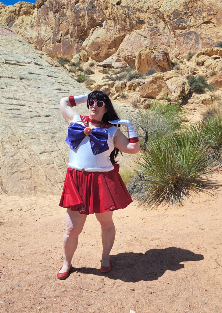 Mars with pink heart-shaped sunglasses, looking perfectly content in the desert.