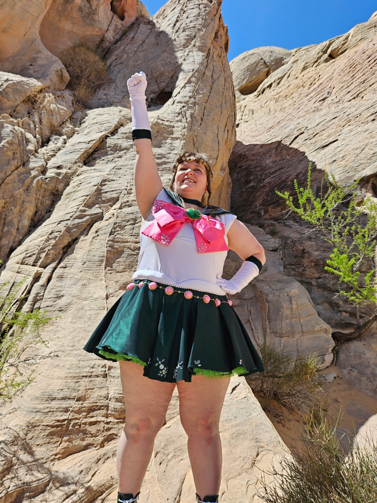 Jupiter with one hand raised in a cheer