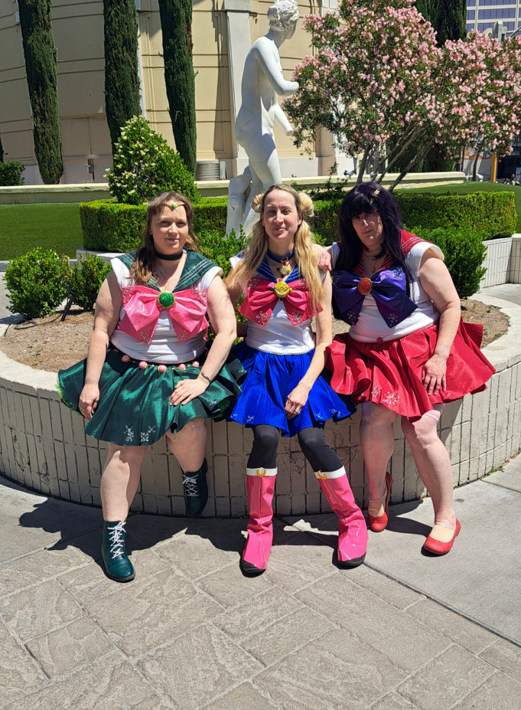 Jupiter, Moon, and Mars sitting in front of a palace and a statue